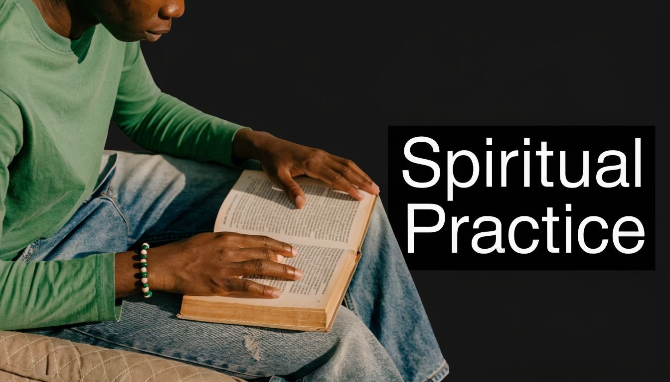 A person wearing a green long-sleeved shirt sitting and reading an open book on their lap.