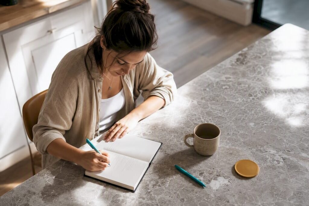 Person writing morning intention journal